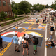 Artists and volunteers paint a Black Lives Matter mural on the street outside the Minnesota African American Heritage Museum and Gallery on July 18 in Minneapolis.